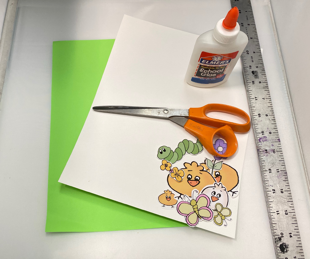 Material needed for making a pop up card; 2 pieces of paper, glue, scissors, clip art and ruler.
